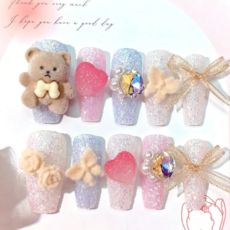 Close-up of cute 3D bow charm on a glossy press-on nail