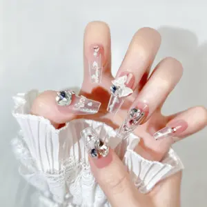 Elegant clear glitter long coffin press-on nails with bows on hand