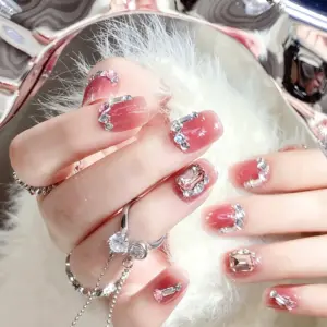 Round and pink accent crystal detail on blush pink press-on nail