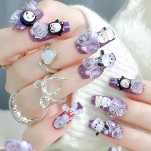 Close up of purple 3D cartoon animal press on nails on a hand