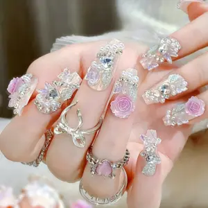 Sparkling rhinestone and butterfly accents on iridescent nails