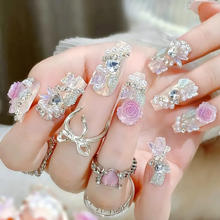 Sparkling rhinestone and butterfly accents on iridescent nails