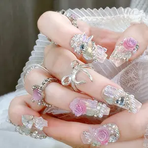 Detailed View Of 3D Pink Rose And Pearl Accents On Iridescent Nails