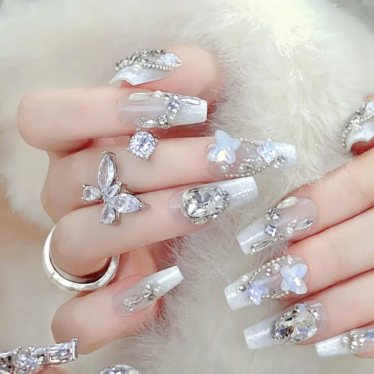 Sparkling rhinestone and butterfly details on white press on nails