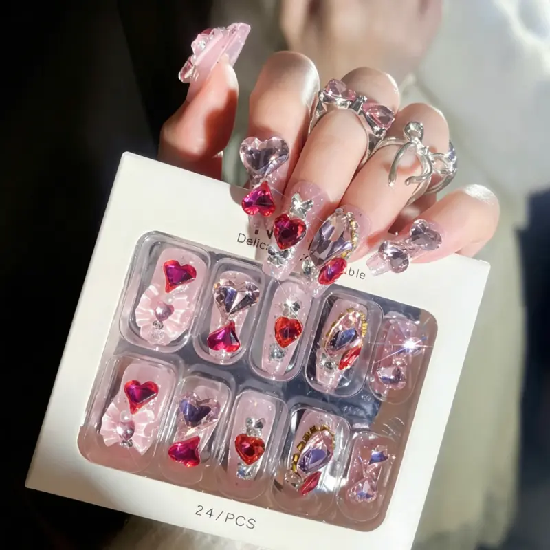 Detailed View Of Sparkling Heart Rhinestones On Pink Glitter Press On Nails