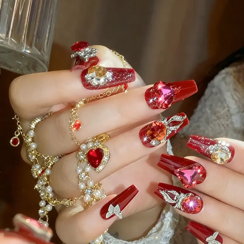 Detailed View Of Sparkling Heart Rhinestones On Red Glitter Press On Nails