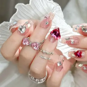 Sparkling heart rhinestone details on pink glitter press on nails