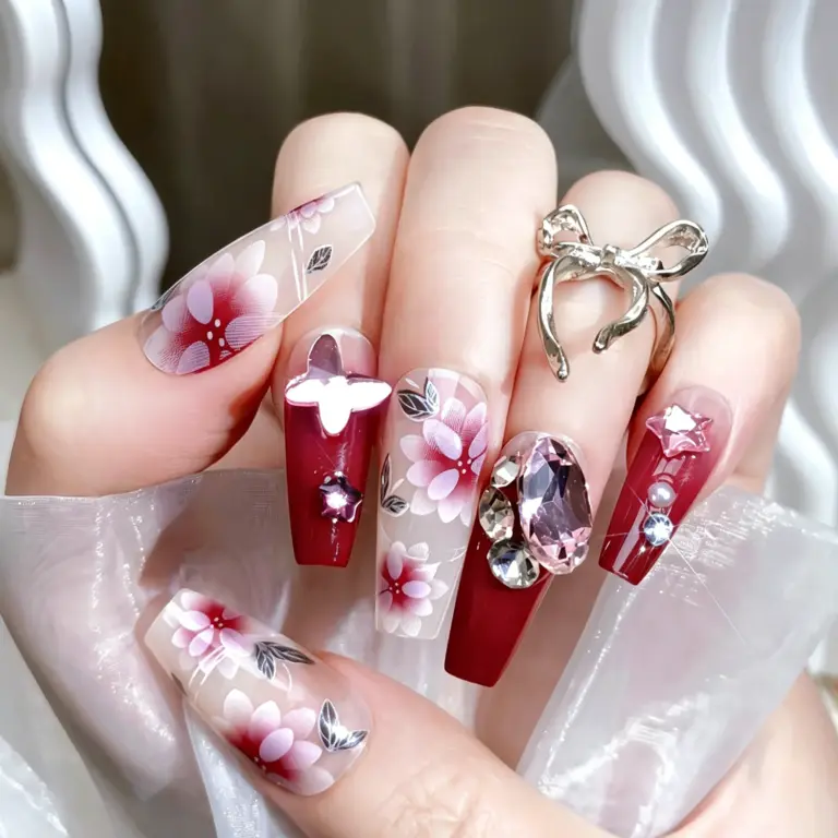 Sparkling rhinestone and butterfly accents on burgundy nails