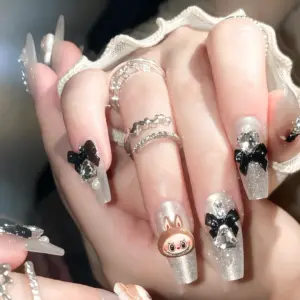 Glossy Black Bow And Rhinestone Accents On Silver Nails