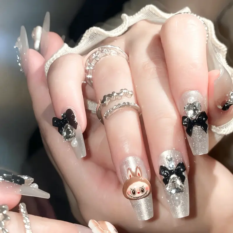 Glossy Black Bow And Rhinestone Accents On Silver Nails