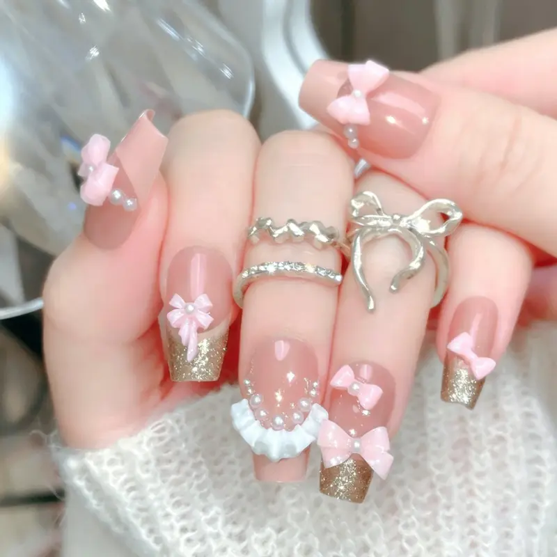 Detailed View Of 3D Pink Bows And Pearls On Nude Pink Nails