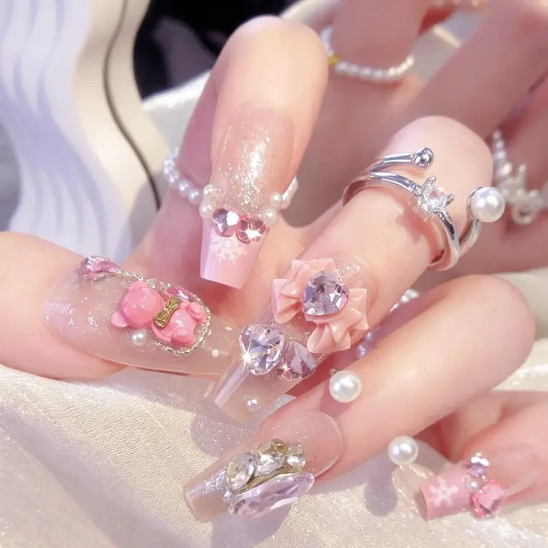 Close up of pink glitter cartoon bear press on nails on hand