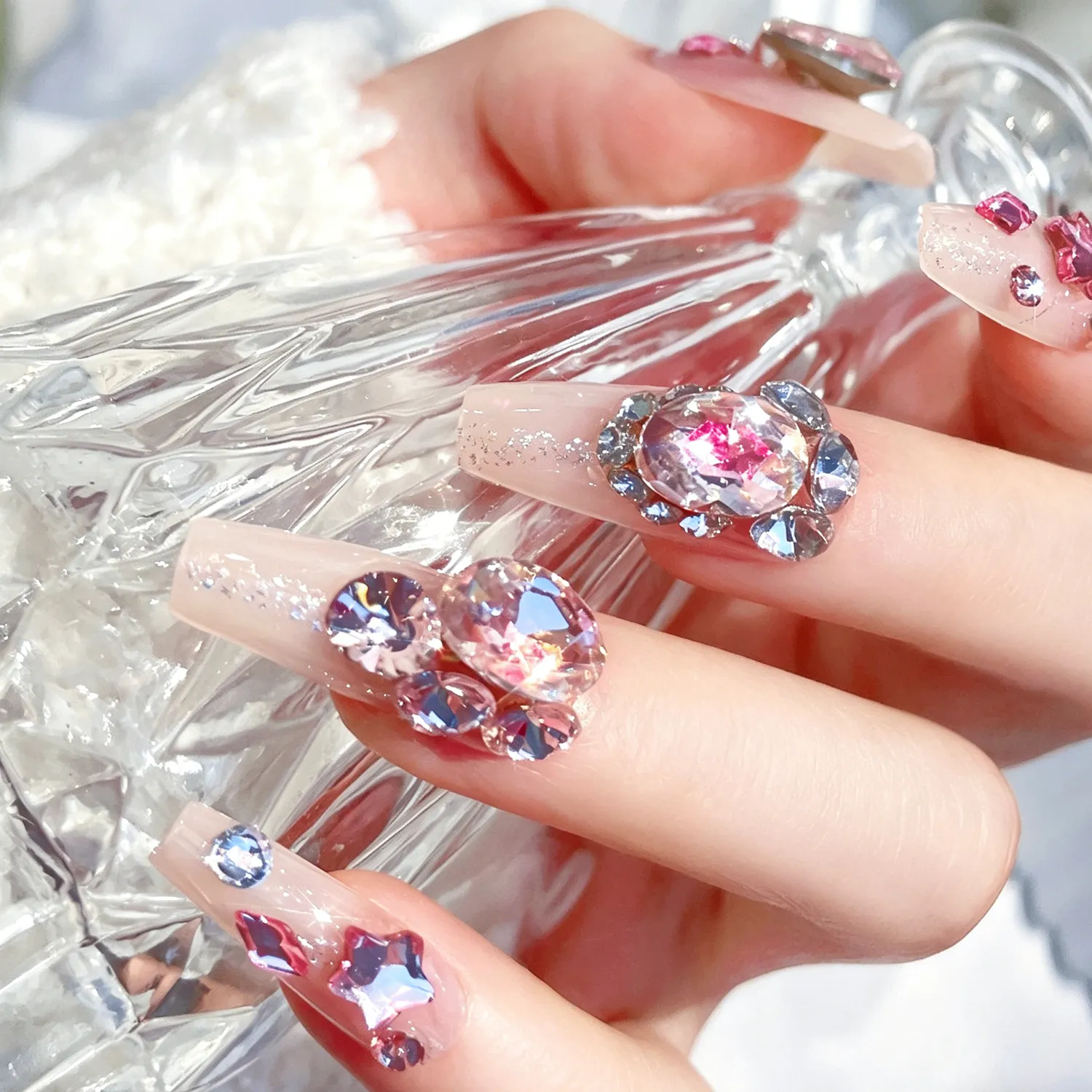Extreme close-up of large shiny rhinestone on press-on nail